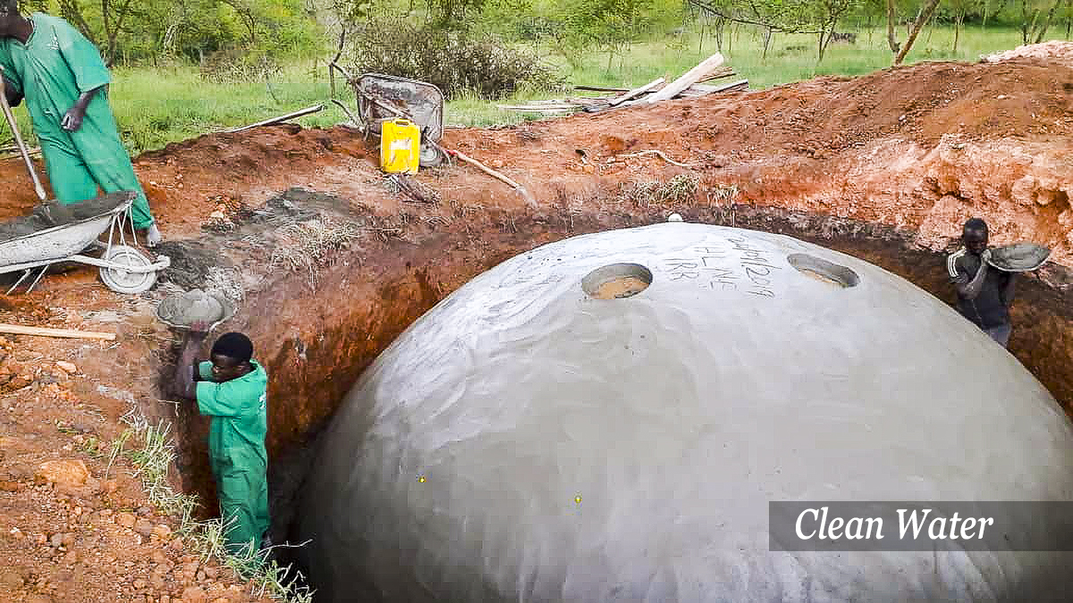 Workmen installing underground water storage tank for access to clean water